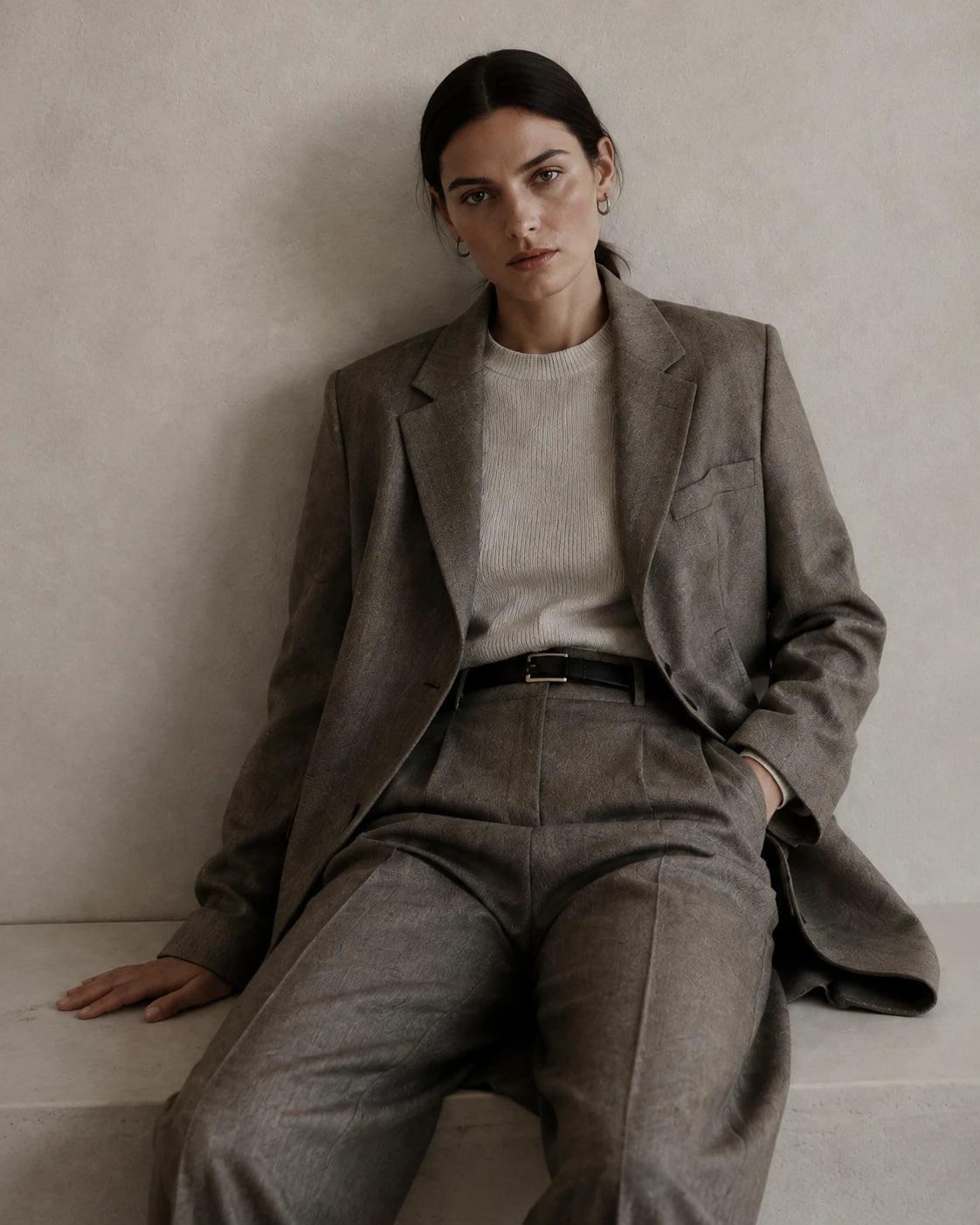 Woman wearing a warm gray tailored suit